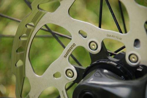 Free Detailed shot of a Shimano disc brake and wheel spindle on a bicycle. Stock Photo