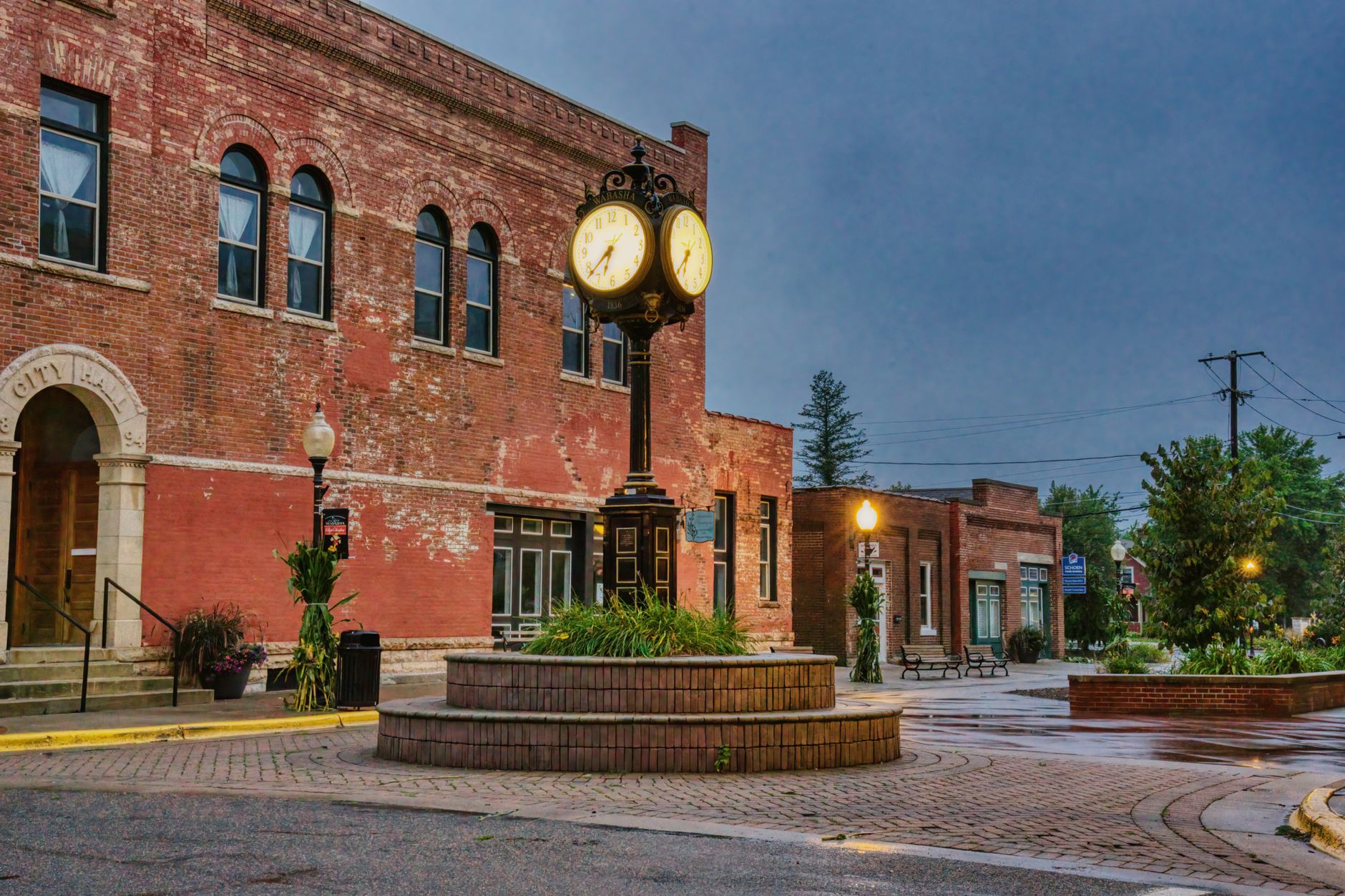 Charming brick building with unique street clock in Wabasha, Minnesota. Urban historic scene at dusk.
