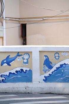 Vibrant urban wall mural featuring dolphins and cartoon figures in a city setting.