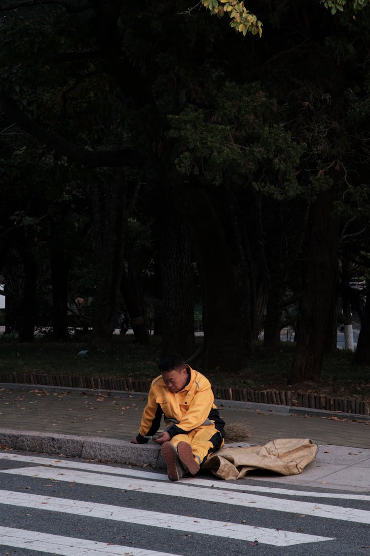 Man Sitting On A Curb