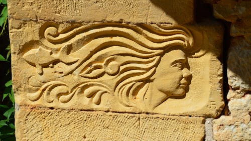 Female Face Carved in Stone