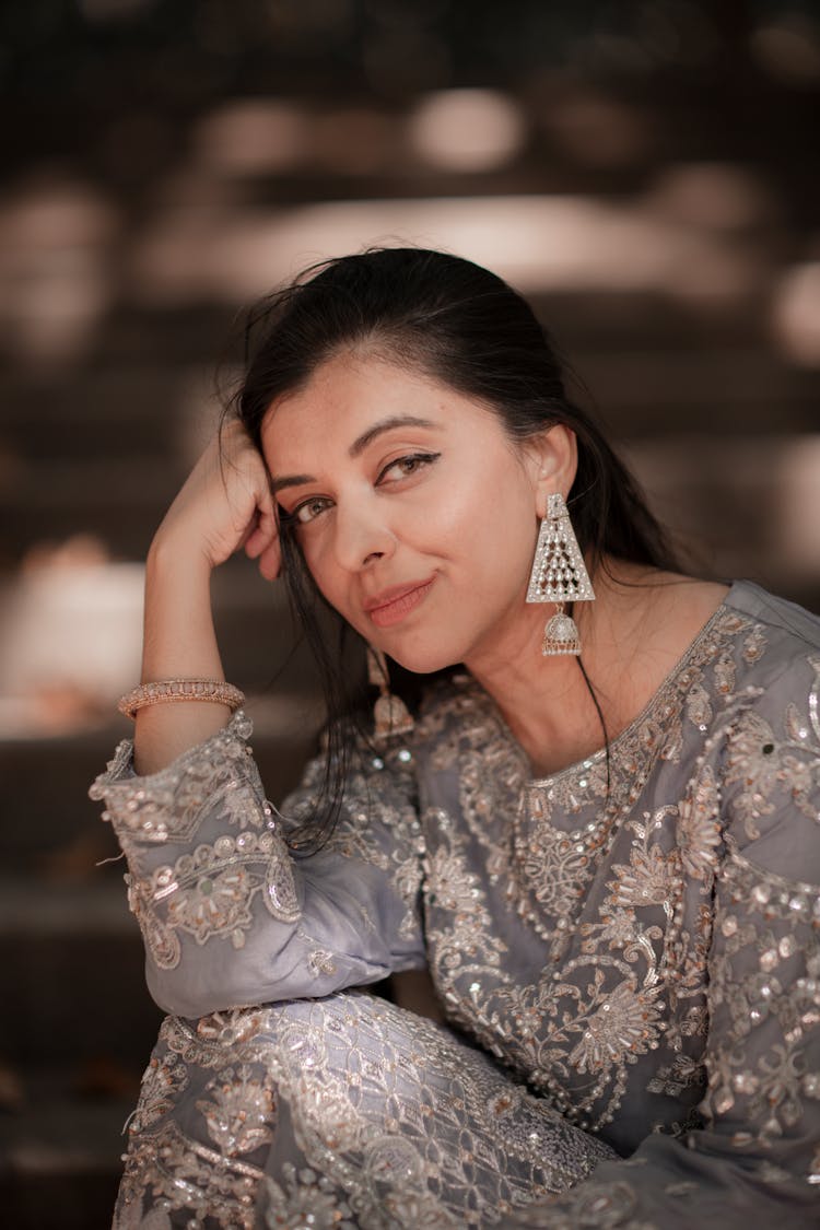 Portrait Of A Woman In A Dress Sitting