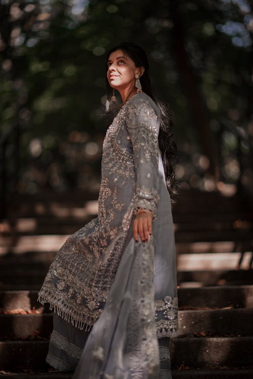 Woman in Traditional Dress Posing in Garden