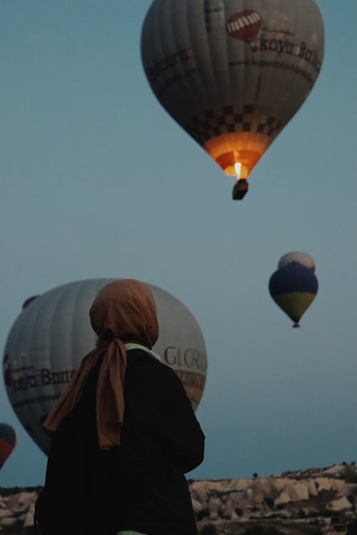 Back View of a Person Looking at Hot Air Balloons