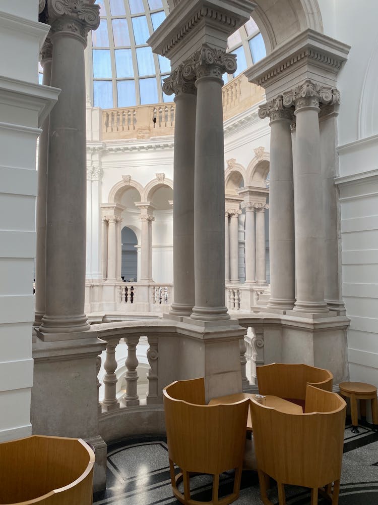 Chairs And Tables By Balcony In Classical Building