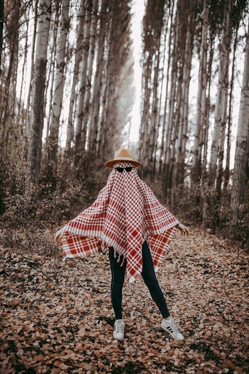 Photo of a Young Woman with a Plaid Scarf on her Face