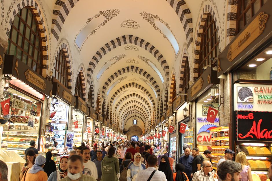 Vibrant interior of the Grand Bazaar in Istanbul, Turkey, with colorful lamps and textiles
