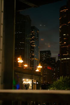 A captivating cityscape at night featuring illuminated skyscrapers and vibrant street lights.