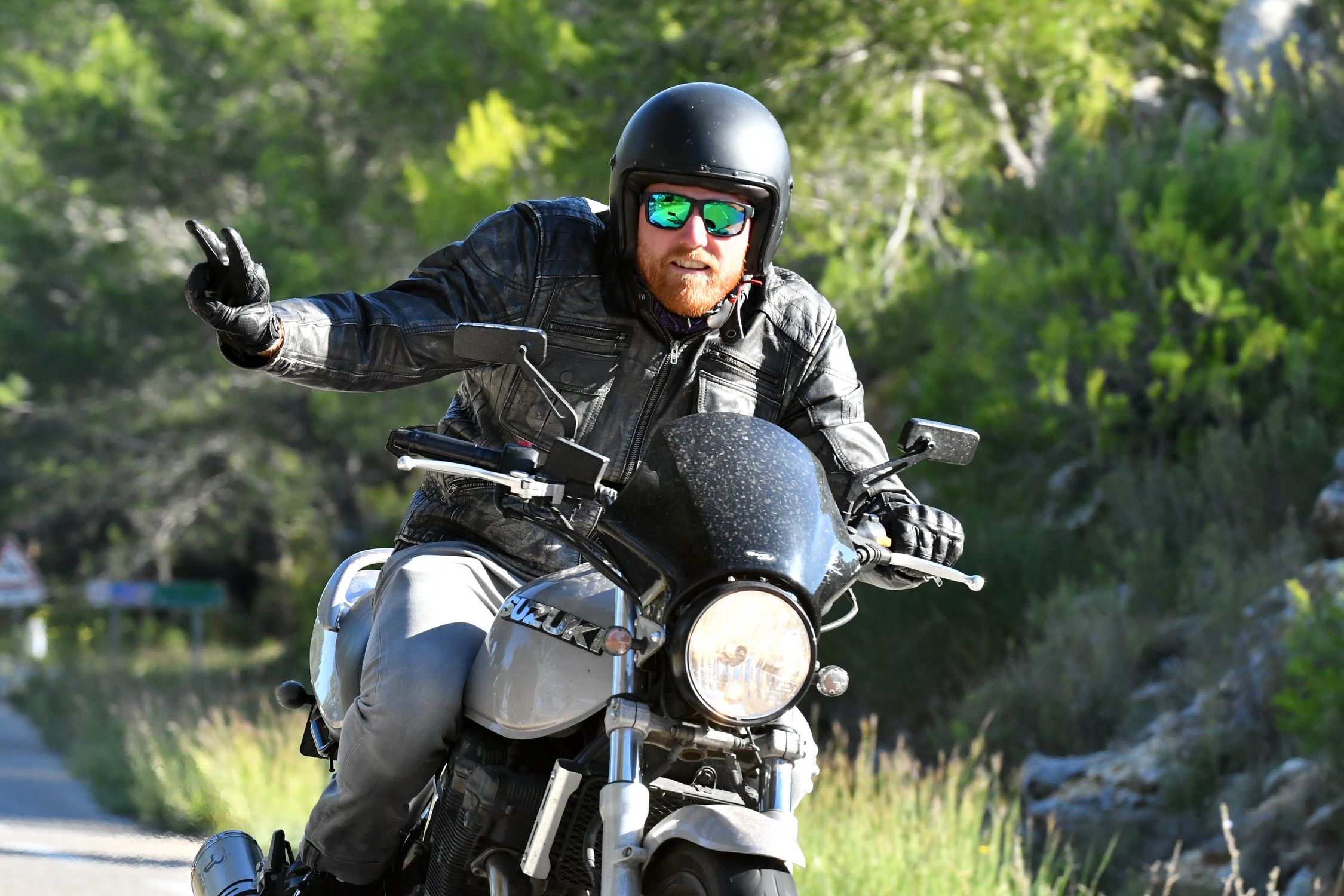 Man Rider Sign Man Riding a Motorcycle doing a Peace Sign · Free Stock Photo
