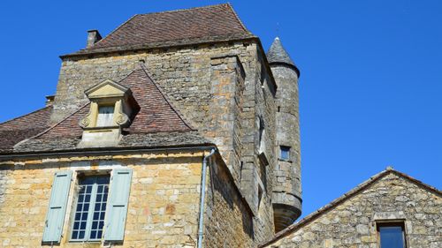 Free Captivating view of a traditional stone castle under a clear blue sky. Stock Photo
