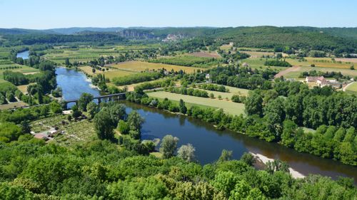 Free A beautiful aerial view of a peaceful countryside landscape with river and lush greenery. Stock Photo
