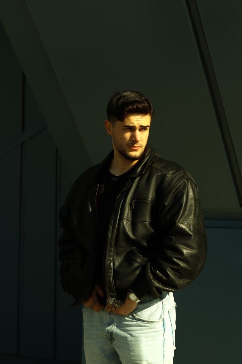Free A stylish bearded man in a black leather jacket poses confidently outdoors in Istanbul. Stock Photo