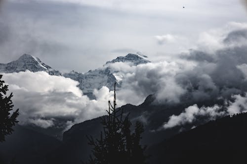 Black and White Photo of Mountains and Clouds 