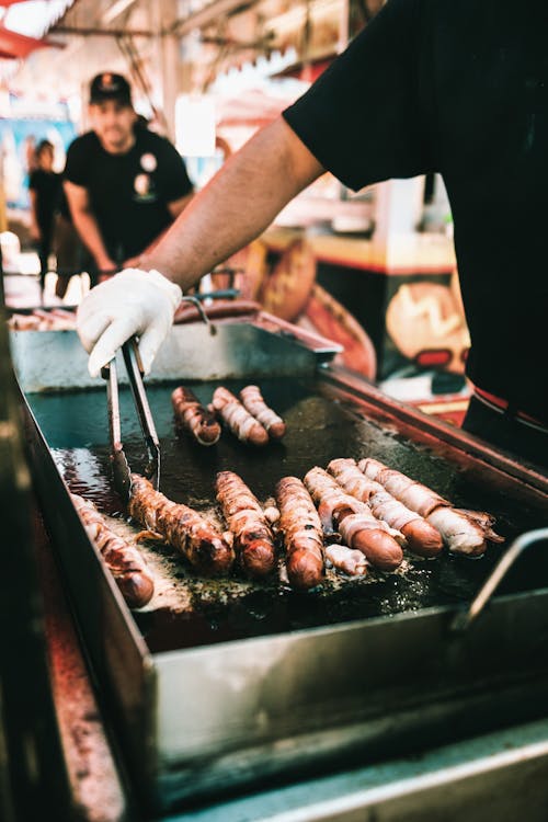 A Person Deep Frying Food