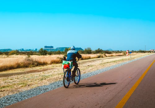 Free Person In Blue Jacket Riding Bicycle Stock Photo