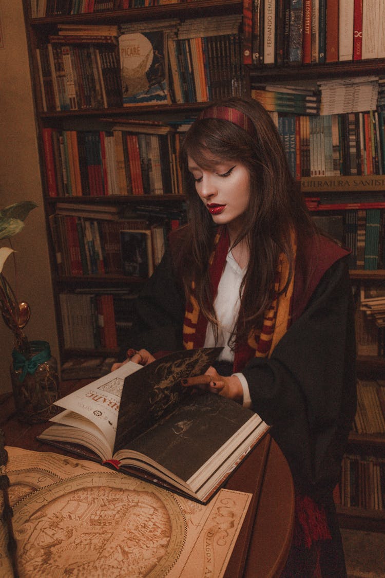 Woman Reading A Book At A Table 