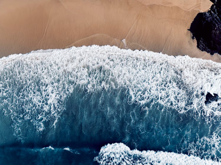 Bird's Eye View  Of Beach Waves Kissing The Shore