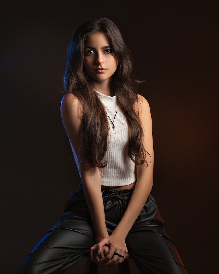 Young Woman Posing On Black Studio Background