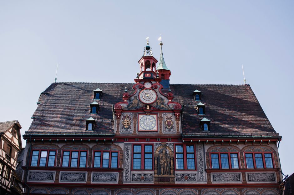 Captivating facade of a historic town hall in Stuttgart, featuring intricate frescoes and classical architecture.