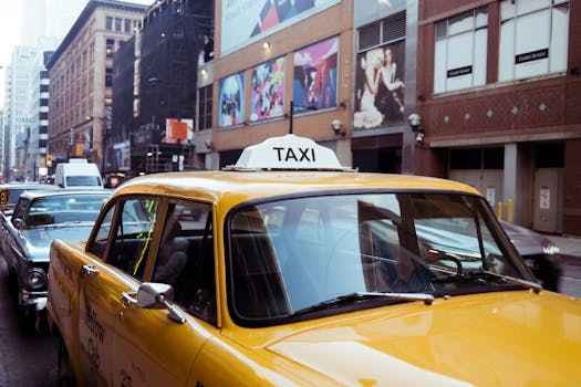 A classic yellow taxi cab navigating through a bustling city street, capturing urban life.