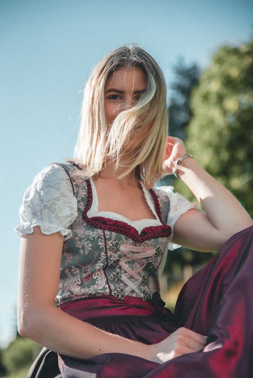 Free Young woman in traditional dirndl dress enjoying the outdoors in Kitzbühel, Austria. Stock Photo