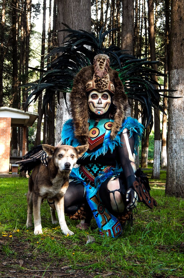 A Person Wearing A Costume For The Day Of The Dead With A Dog