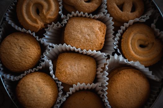 Top view of assorted butter cookies in a tin, perfect for holiday treats.