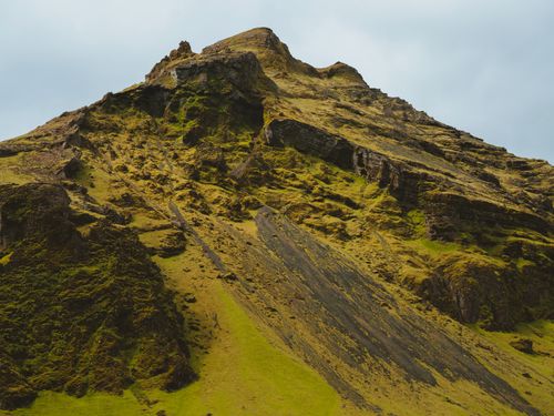 Free Captured is a stunning landscape featuring a mountain with rugged terrain and lush vegetation. Stock Photo