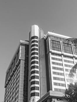 Monochrome view of a modern high-rise building in Mumbai, showcasing architectural design.