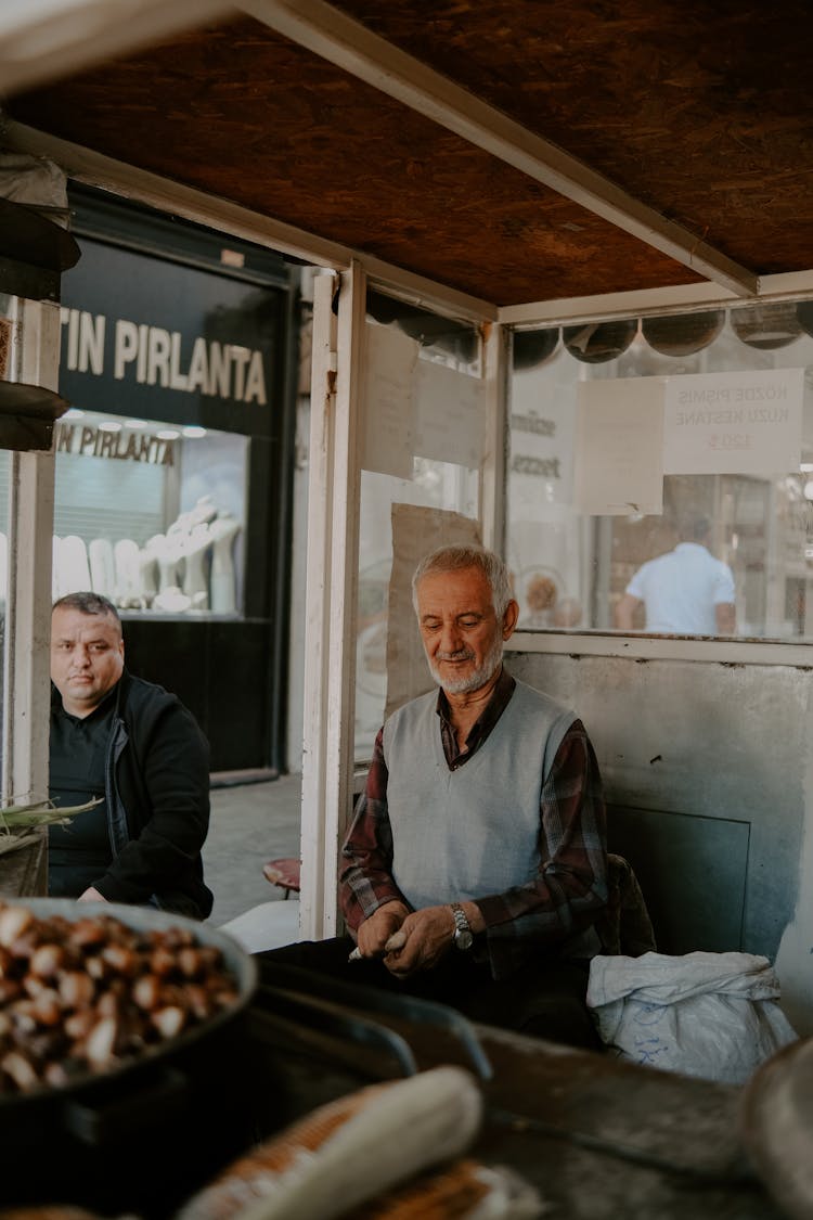 An Elderly Man In The Food Stall