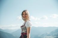 Smiling Woman Wearing White And Green Floral Cuff-shoulder Dress
