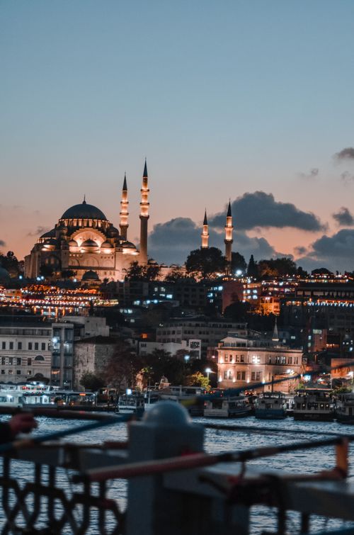 Free Breathtaking twilight view of the Suleymaniye Mosque amidst Istanbul's cityscape, featuring city lights and minarets. Stock Photo