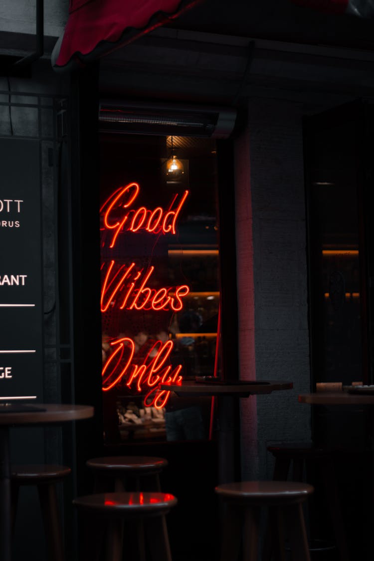 A LED Neon Signage On The Glass Window Of A Café