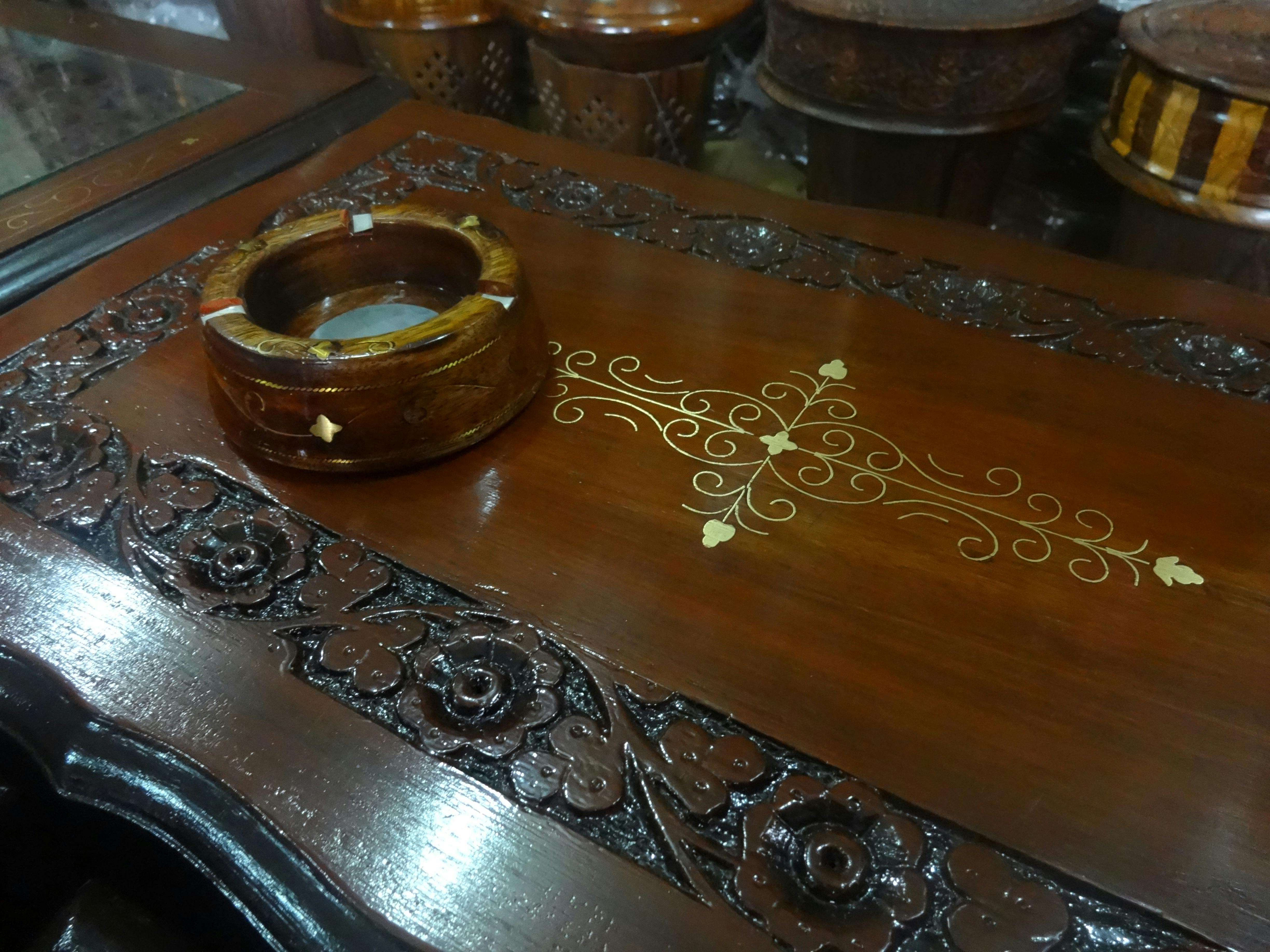 Free stock photo of ashtray, carved wood, wooden table