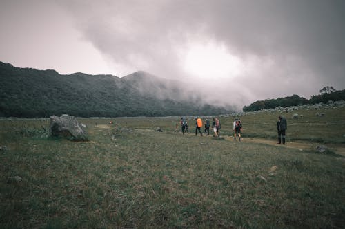 People Trekking in the Countryside
