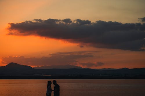 Silhouette of a Romantic Couple on the Beach during Sunset