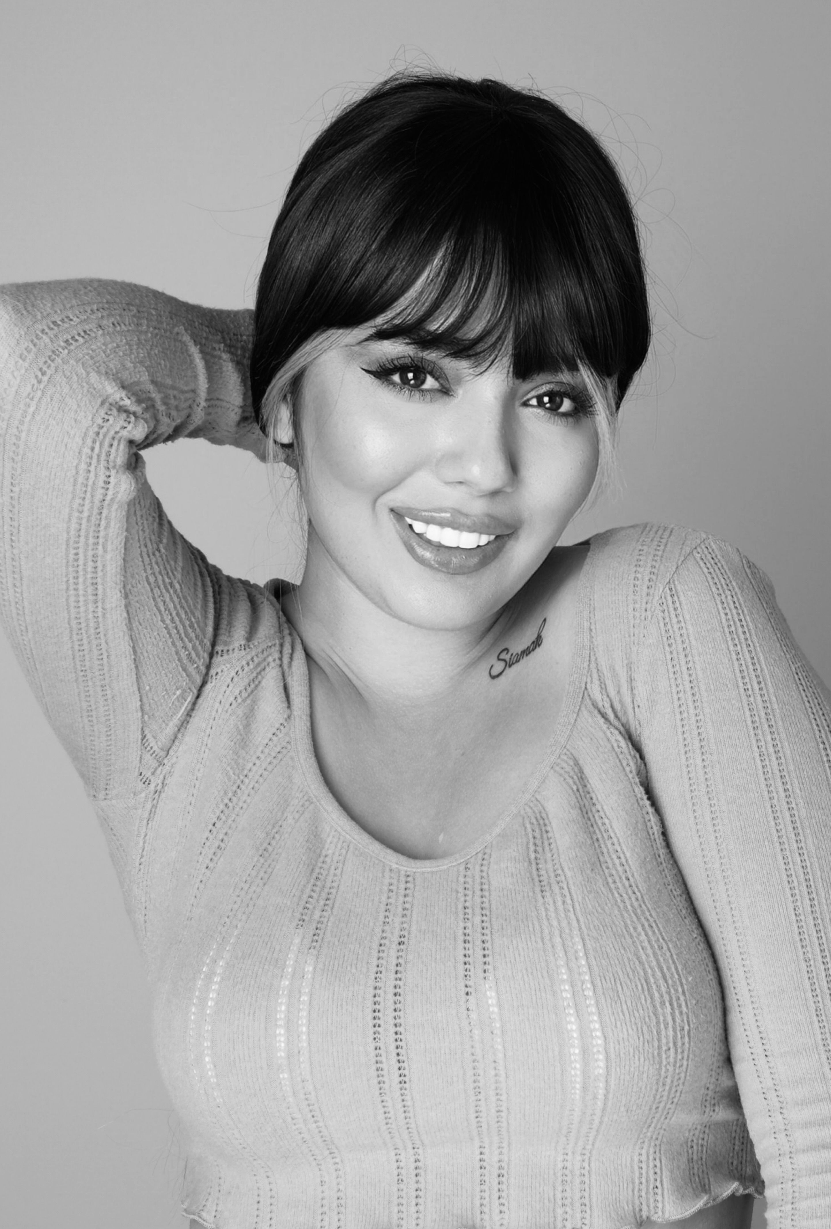 Beautiful monochrome portrait of a woman smiling with graceful pose.