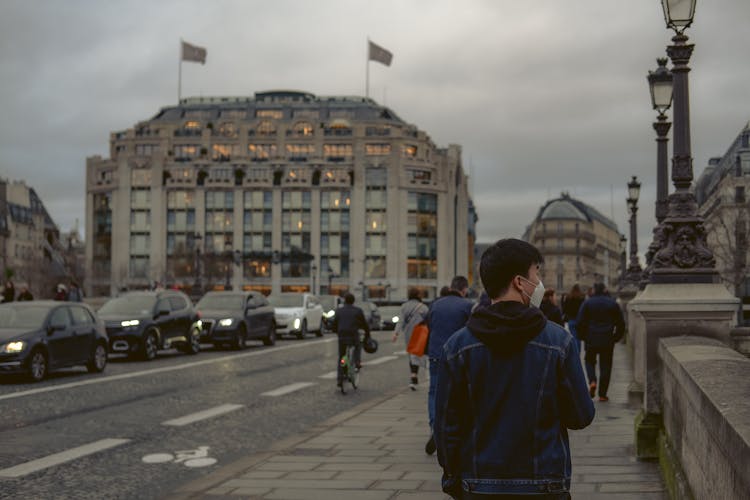 People Walking On Sidewalk In City