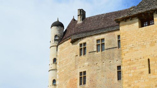 Free Close-up view of a historic stone castle tower with a blue sky backdrop, showcasing medieval architecture. Stock Photo