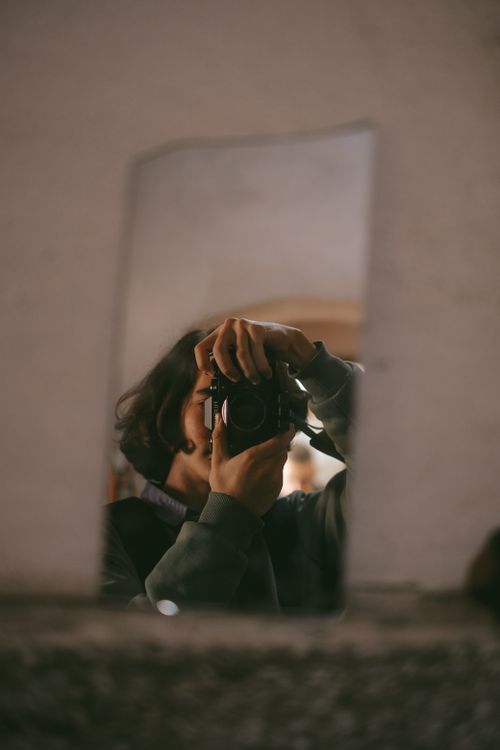 Free Captivating image of a photographer capturing their reflection in a broken mirror indoors. Stock Photo