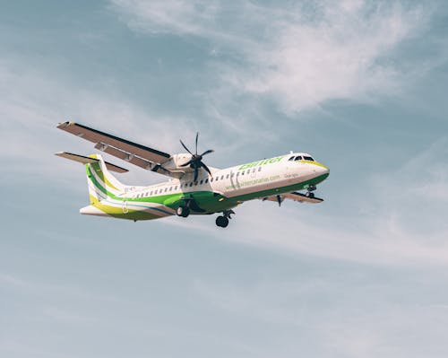 Green and White Airplane in the Sky