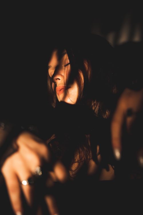 Free Artistic portrait of a woman with dramatic shadows on her face. Stock Photo