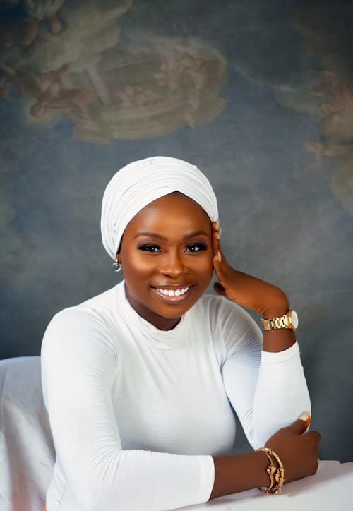 Smiling Woman in White Long Sleeves with Headwrap 