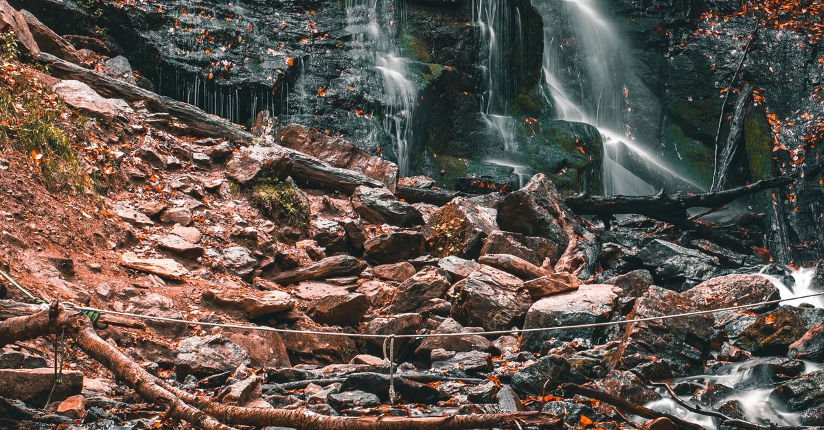 Waterfall Cascading over Cliff Rocks · Free Stock Photo
