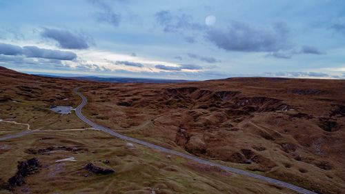 Free Stunning aerial view of the Brecon Beacons, Wales at sunrise with rolling hills and a curving road. Stock Photo