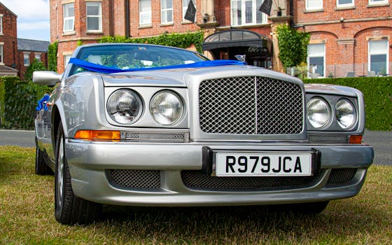 Luxury silver Bentley parked in front of a historic mansion in Lytham St Annes, England.
