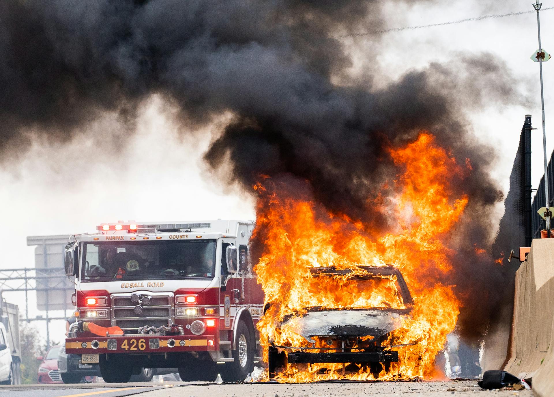 Firetruck Next to Burning Car on Street