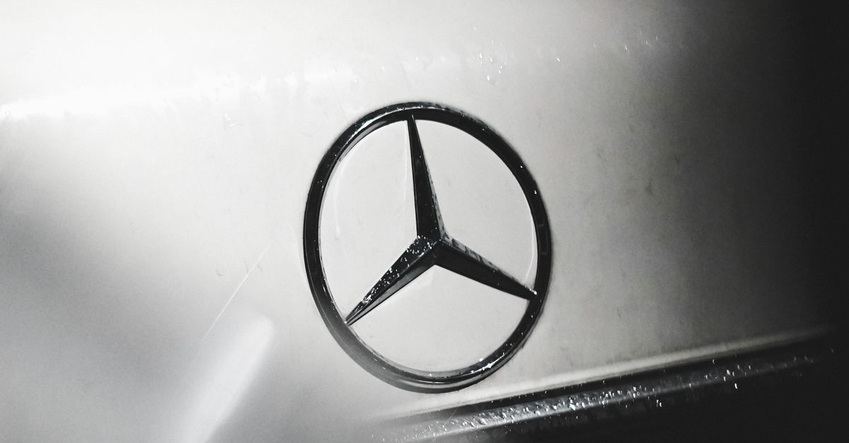 Mercedes Sign Appendix Sign of Mercedes Benz on a Car Trunk · Free Stock Photo