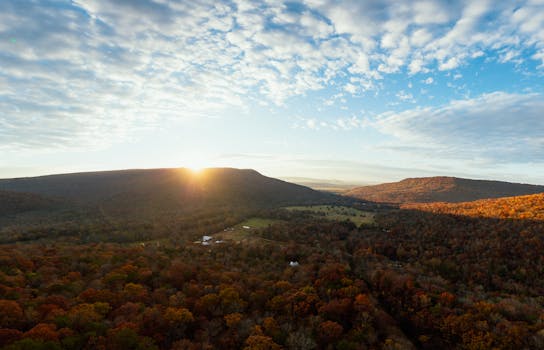 Breathtaking aerial view of Sequatchie Valley with sunrise over autumnal mountains and vibrant fall foliage.