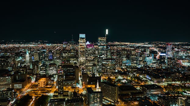 Stunning aerial view of Philadelphia at night showcasing skyscrapers and city lights.